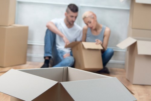 Organised moving boxes labeled for rooms in a Holloway flat