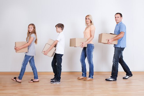 Unpacking boxes in a Holloway flat after moving day