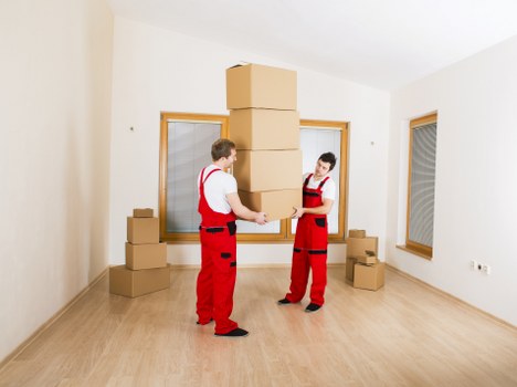 Professional movers handling items with safety focus